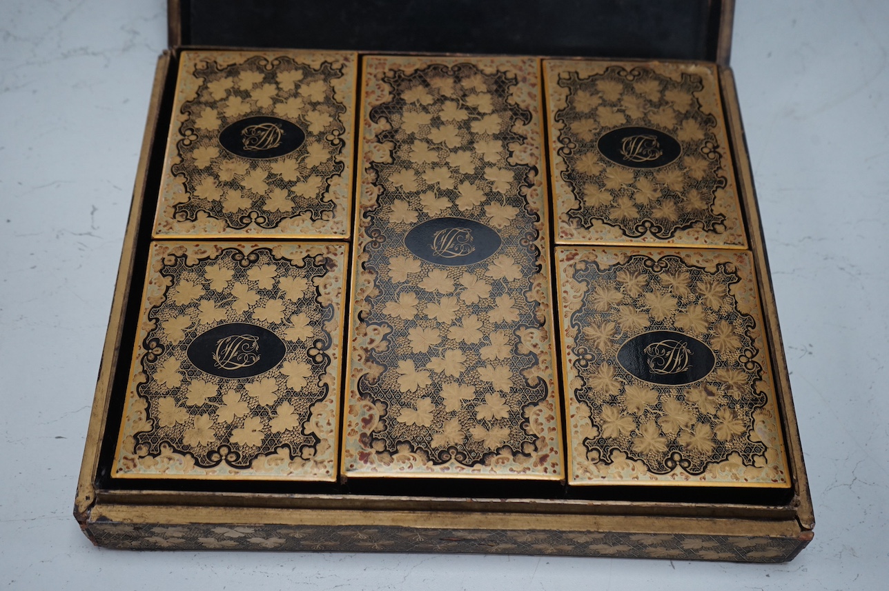 A mid 19th century Chinese gilt decorated and black lacquer games box, with five internal gilt and lacquered boxes, 30cm wide x 26cm deep. Condition - outer box split to top, gilding worn, edges worn, interior boxed as n